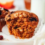 Baked morning glory muffins topped with walnuts and dried fruit