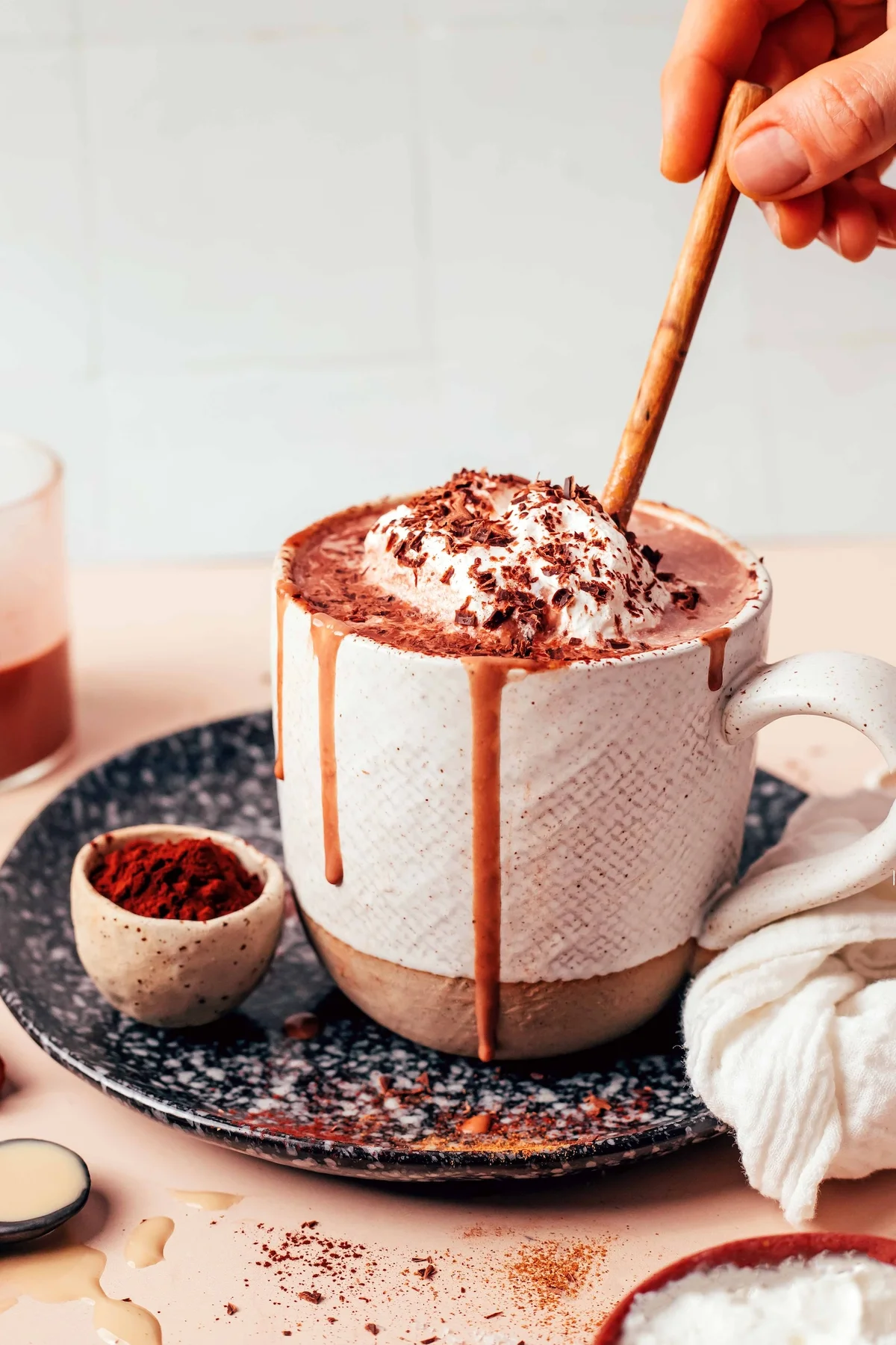 Mug of creamy tahini hot chocolate topped with whipped cream