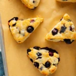 Tray of golden, freshly baked blueberry scones