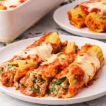 Baked manicotti shells with sausage and melted cheese