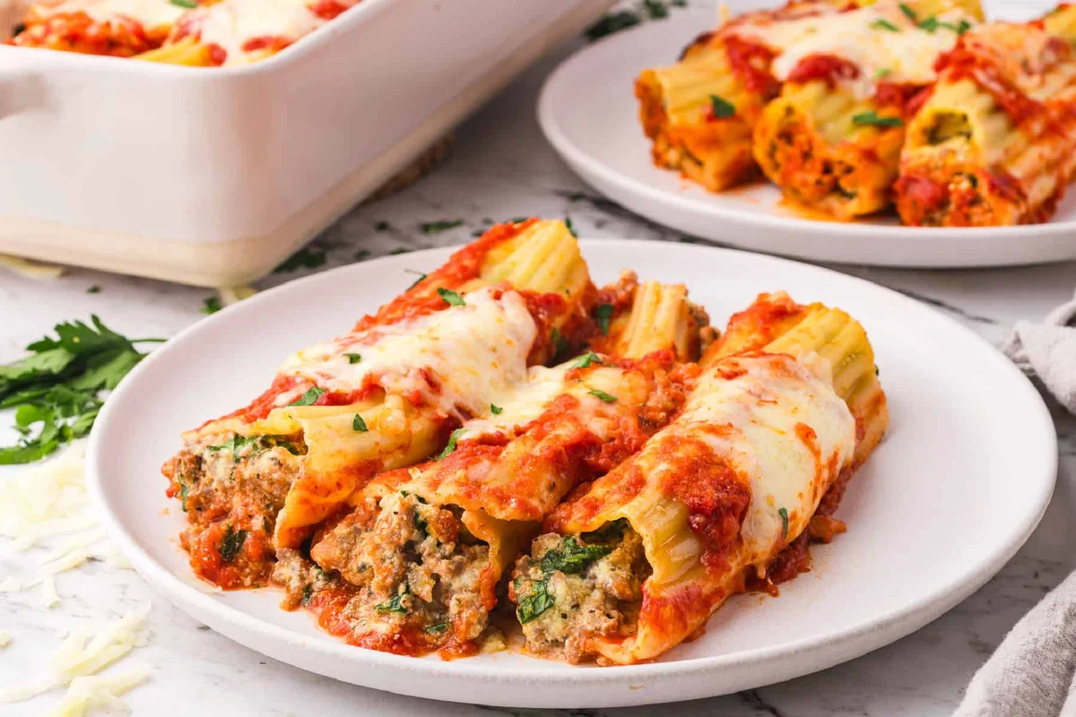 Baked manicotti shells with sausage and melted cheese