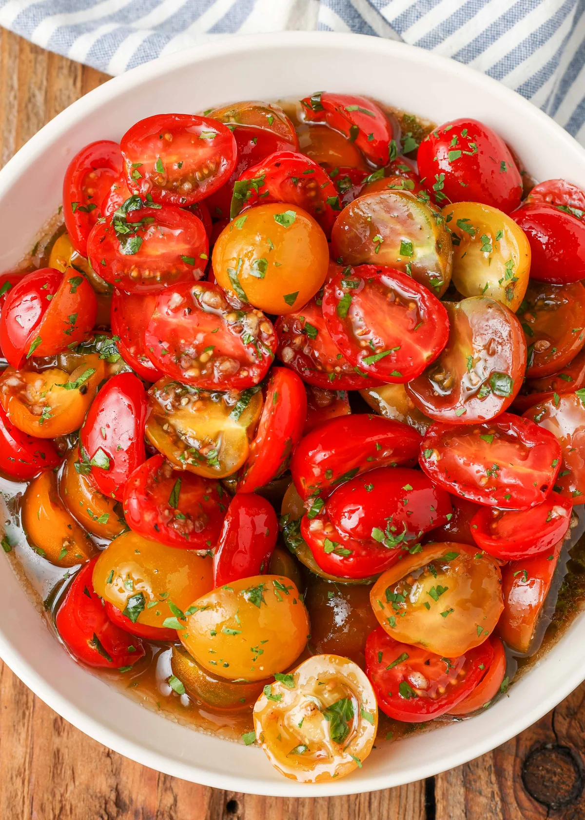 Bowl of heirloom marinated tomatoes with fresh herbs