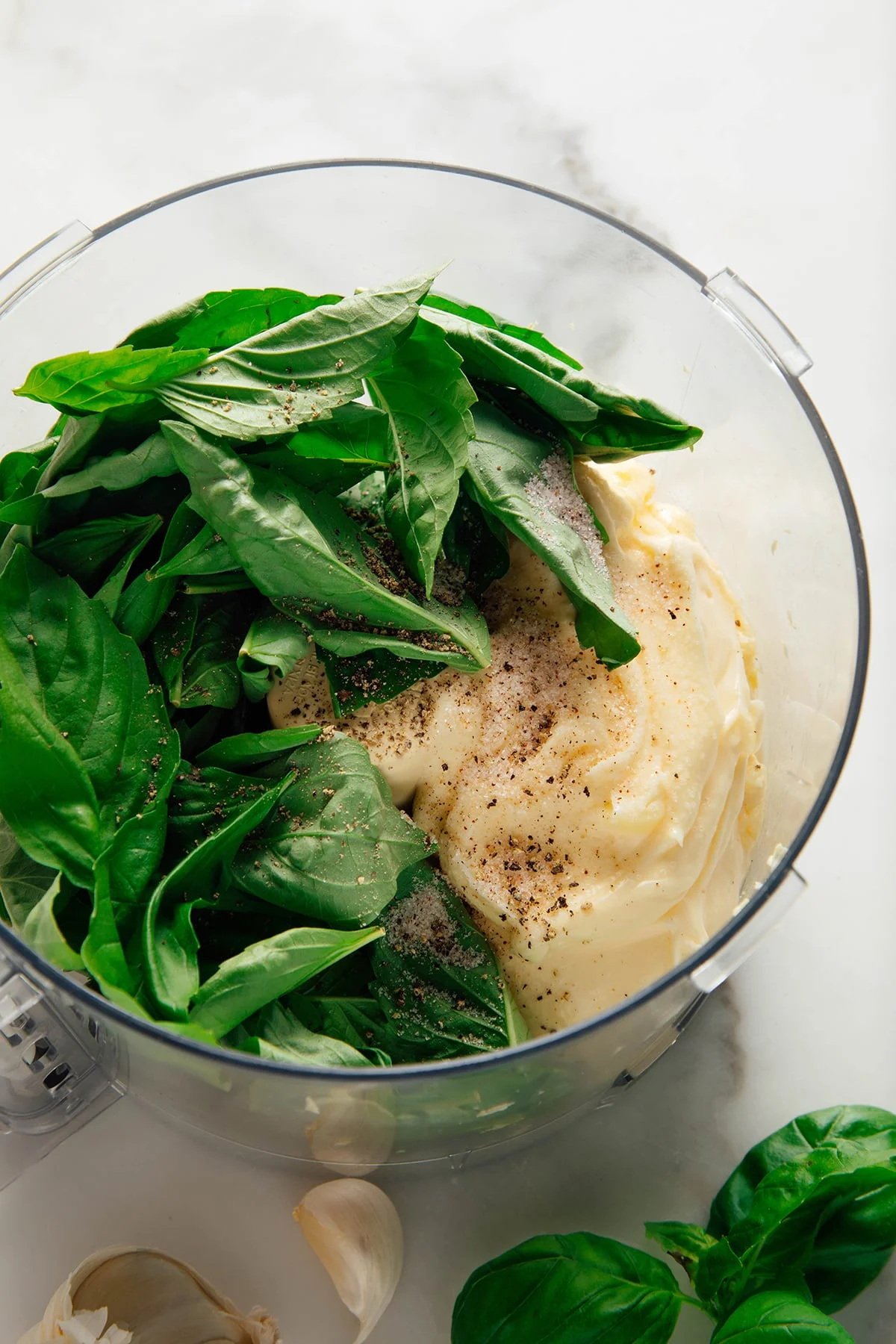 Creamy basil sauce in a white bowl with basil garnish
