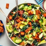 Bowl of vegan sweet potato chickpea taco salad with chips and avocado