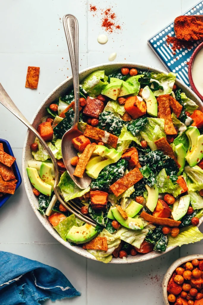 Bowl of vegan sweet potato chickpea taco salad with chips and avocado