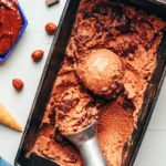 Chocolate hazelnut ice cream swirled in a metal pan with cones