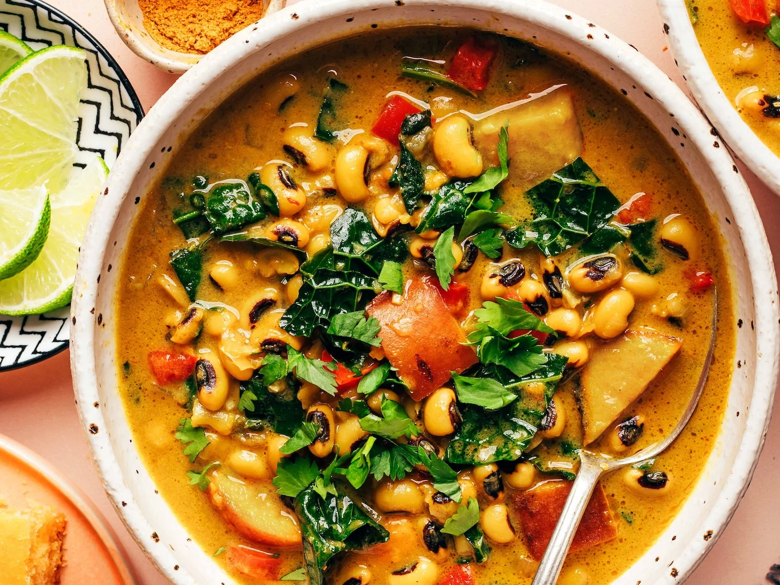 Creamy curried black eyed pea soup in a bowl with kale