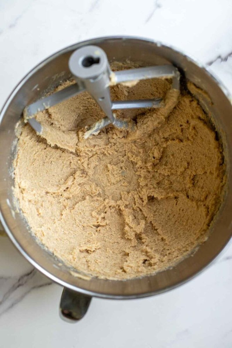 Scoops of cookie dough on a parchment-lined baking sheet