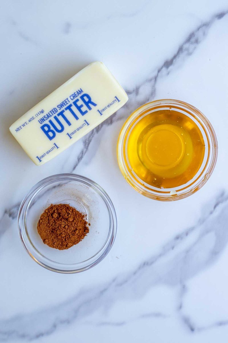 Butter, honey, and cinnamon laid out on marble