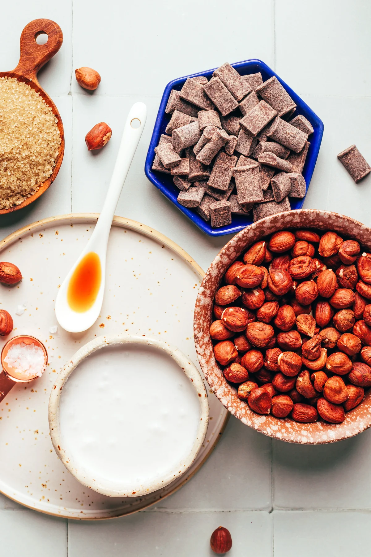 Hazelnuts, chocolate chunks, and cane sugar laid out