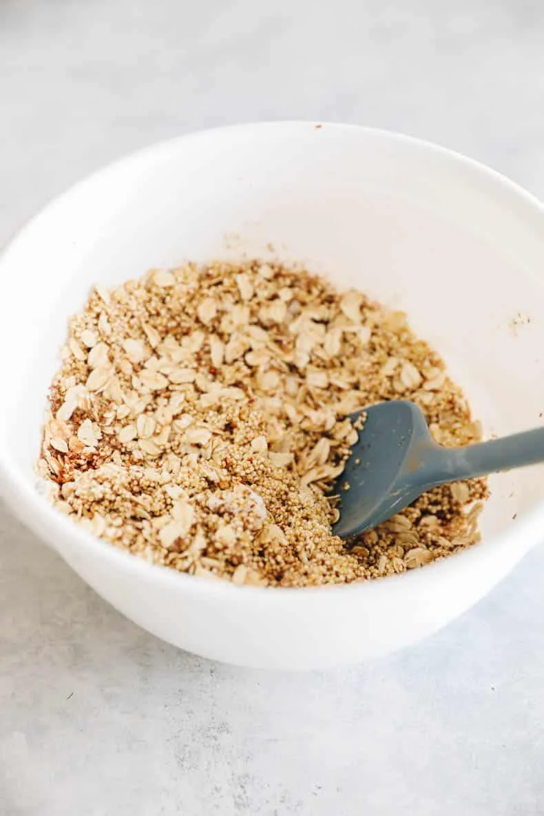 Blueberry oat bar batter folded with fresh blueberries in a bowl