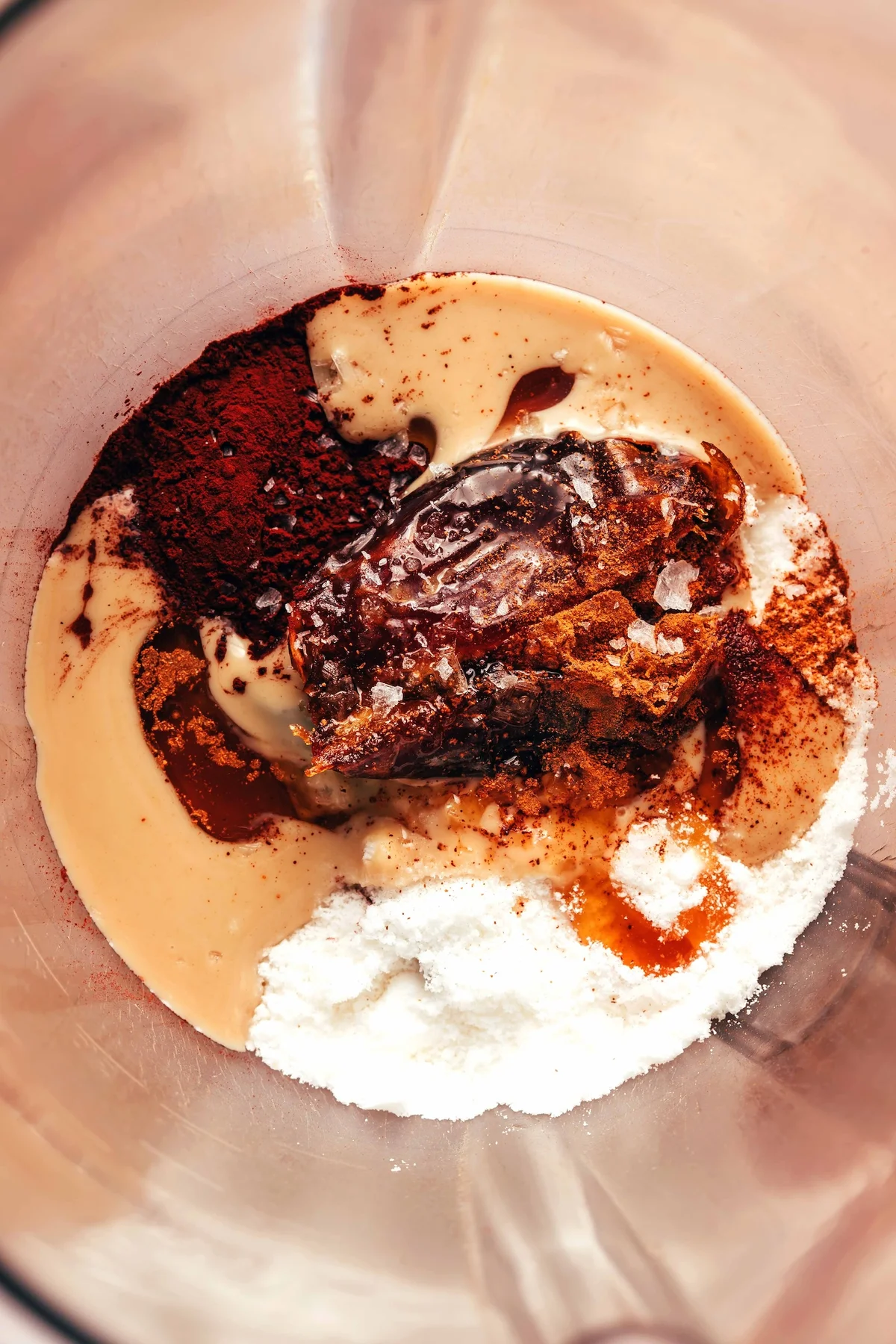 Hot chocolate ingredients layered inside a heat-safe blender