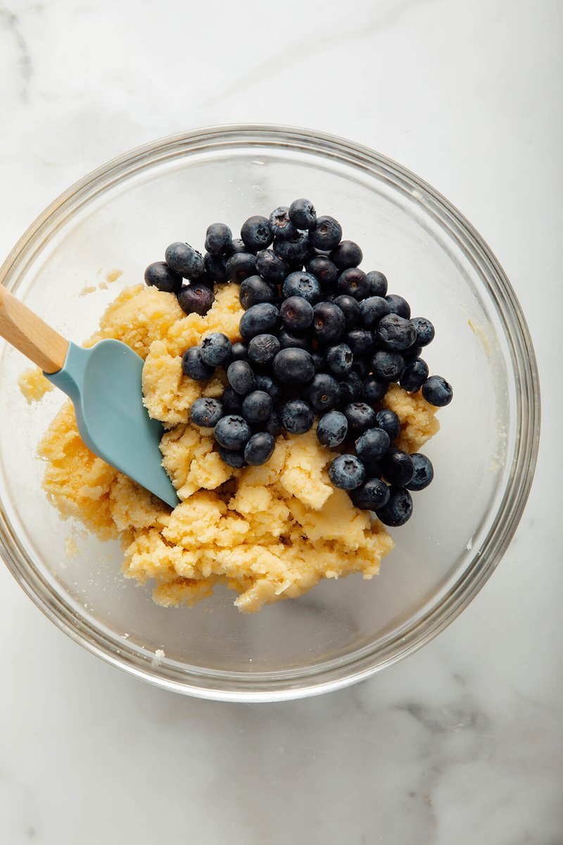 Blueberry scone dough being mixed in a glass bowl