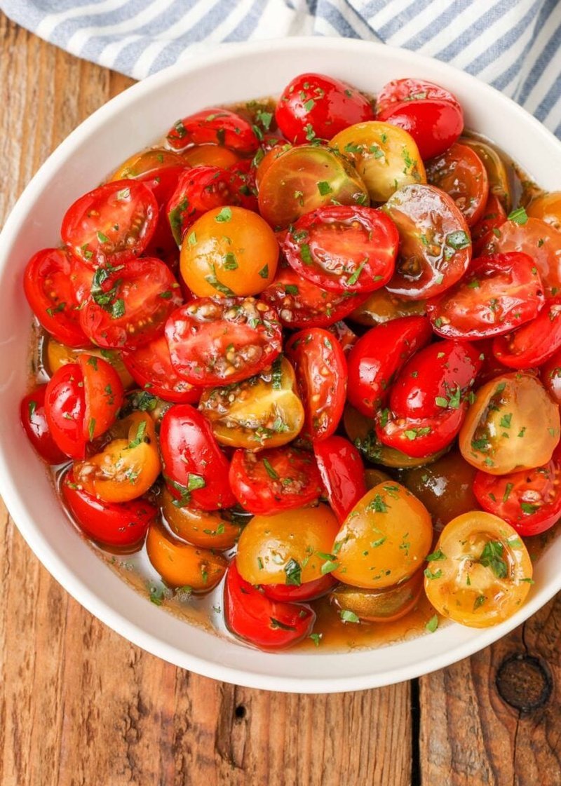 Marinated tomatoes served alongside grilled chicken and rice