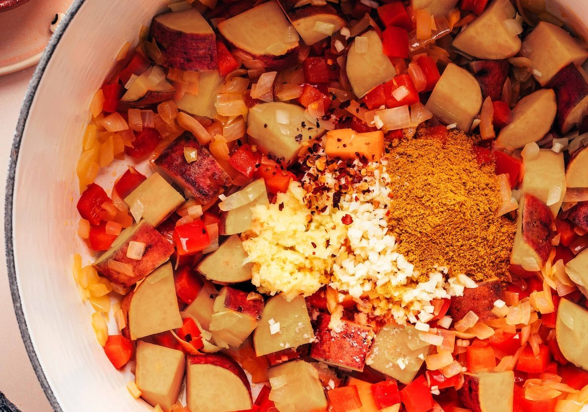 Vegetables and curry simmering in a large pot