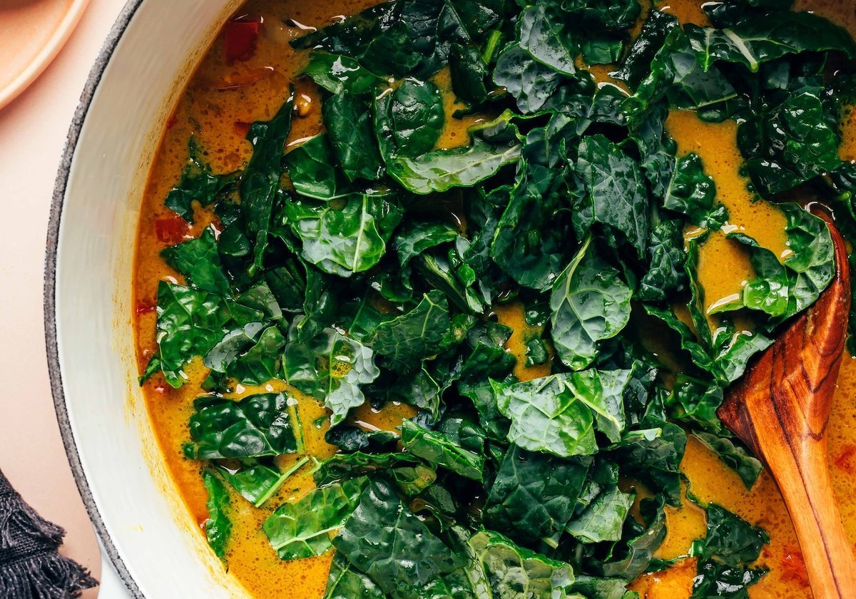 Finished curried pea soup bowl garnished with kale