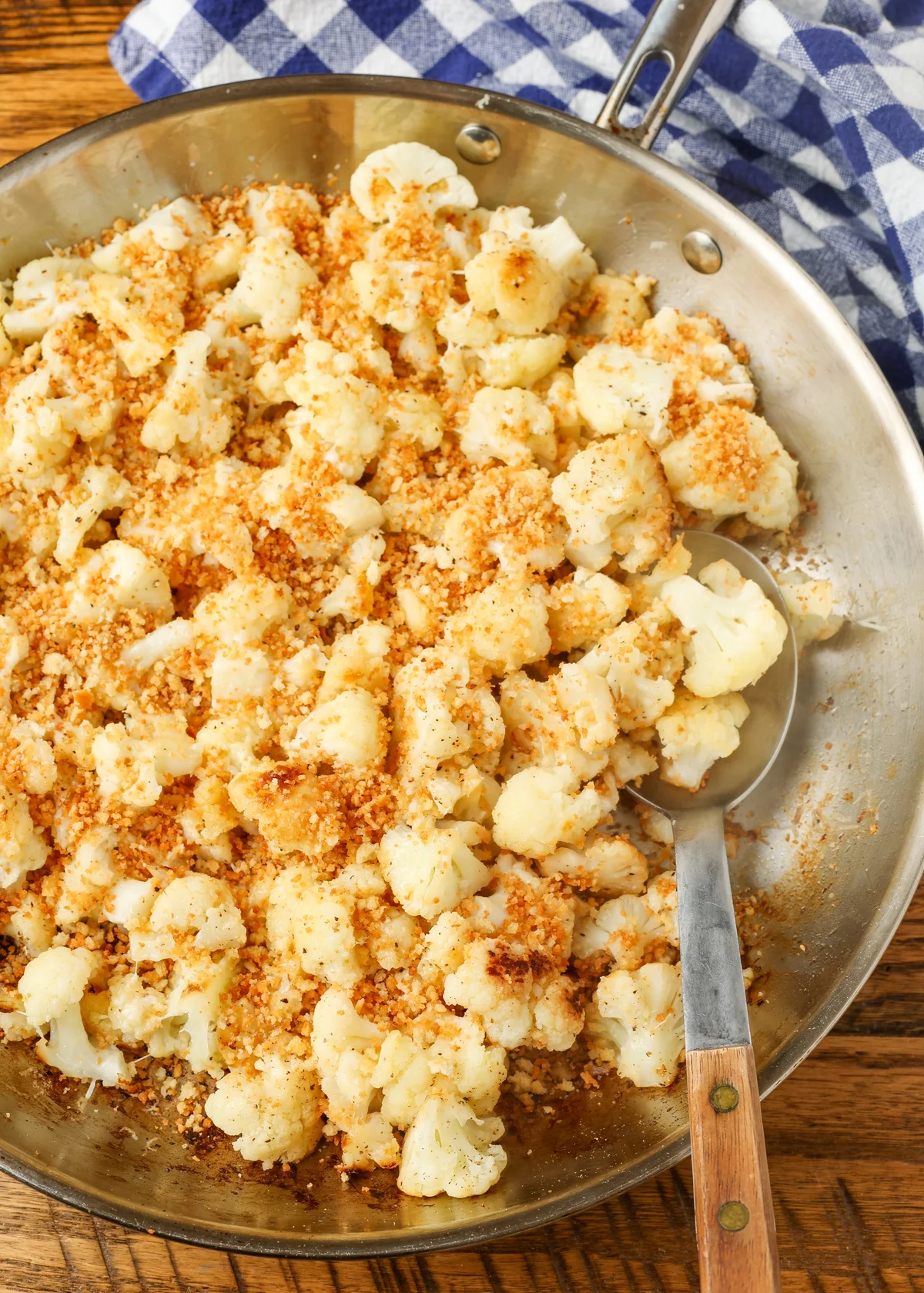 Cheesy sauteed cauliflower topped with toasted breadcrumbs in a skillet