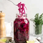 Jar of bright pink quick pickled red cabbage with lime