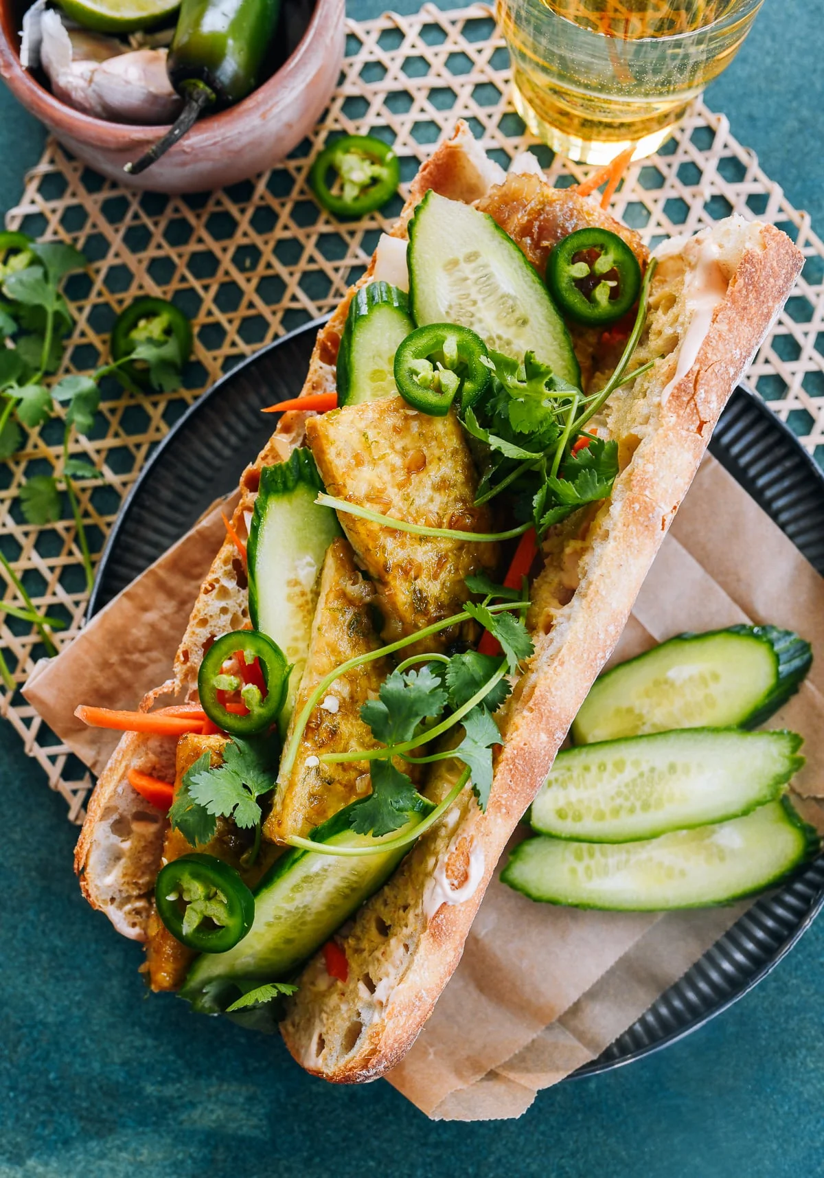Loaded tofu bánh mì with pickled carrots, cucumber, cilantro, and Sriracha mayo