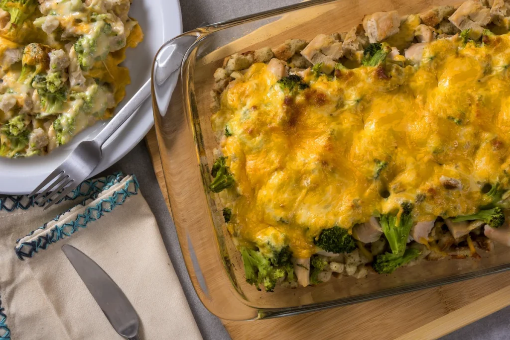 Golden cheesy chicken and broccoli casserole with stuffing in a baking dish