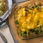 Golden cheesy chicken and broccoli casserole with stuffing in a baking dish