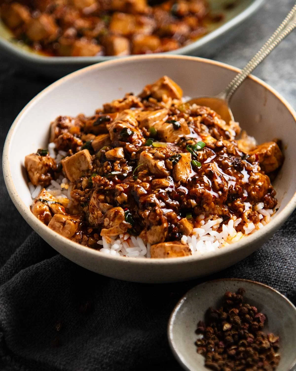 Finished mapo tofu with glossy red sauce and green onion