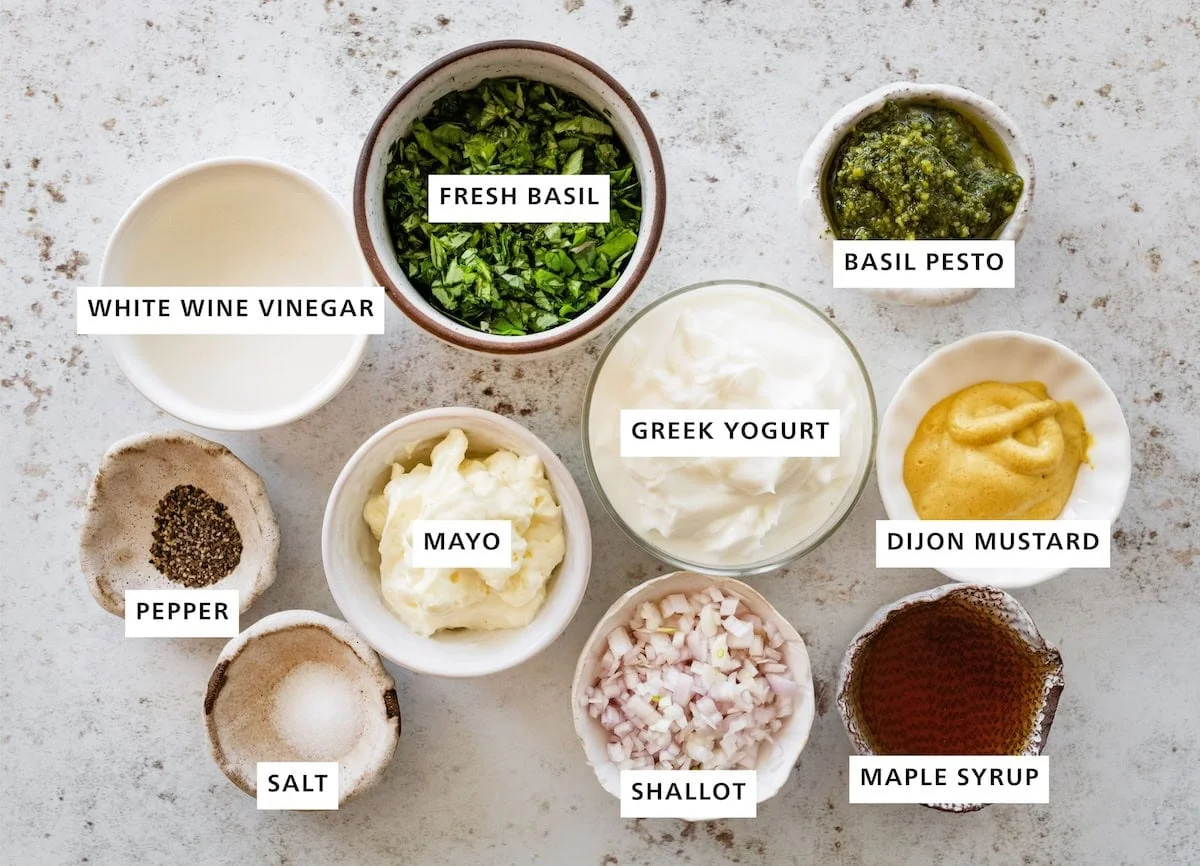 Flat-lay of salad dressing ingredients in small labeled bowls