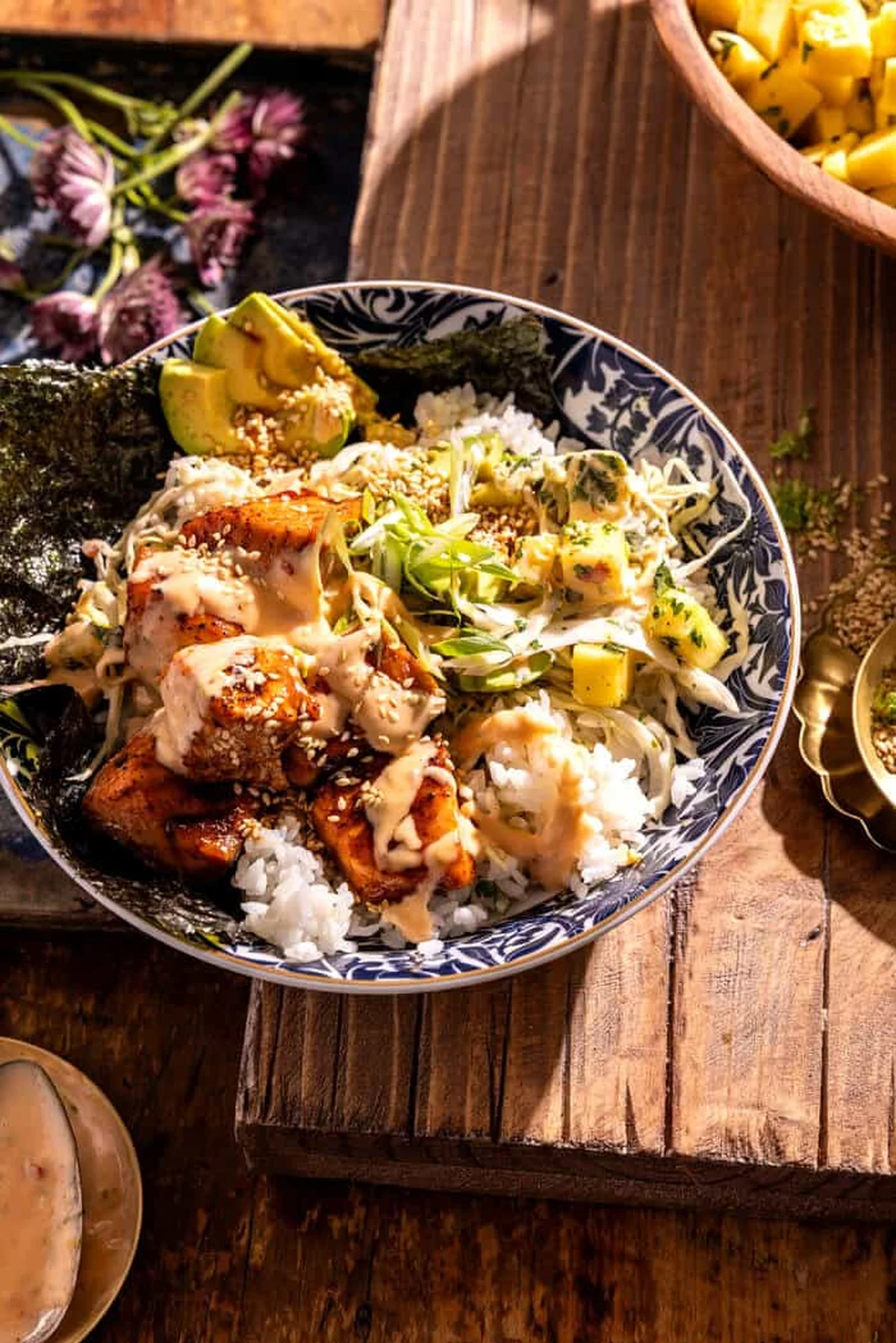 Close-up of salmon bowl topped with slaw and avocado