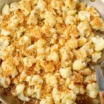 Top-down view of golden sauteed cauliflower with crisp crumbs in a pan