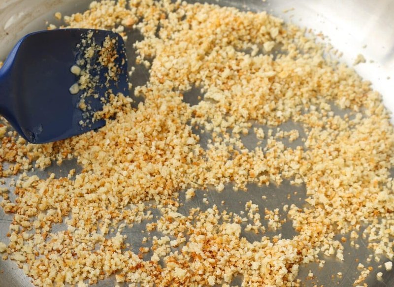 Toasted golden panko breadcrumbs coating the bottom of a skillet