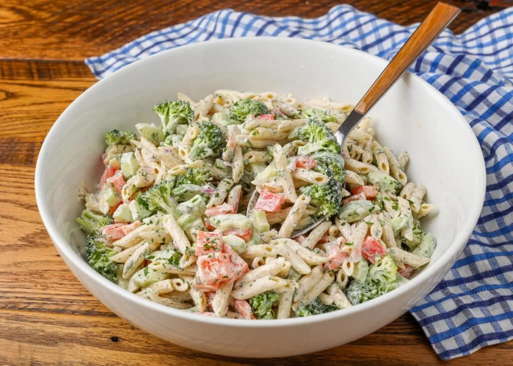 Finished pasta salad in bowl with serving spoon