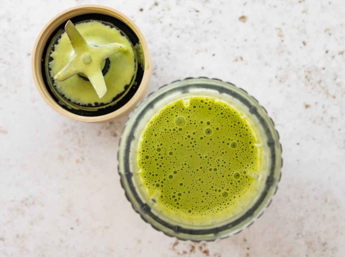 Smooth green goddess dressing freshly blended in a glass jar