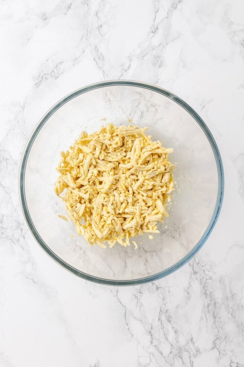Grated tofu coated with cornstarch and seasonings in bowl