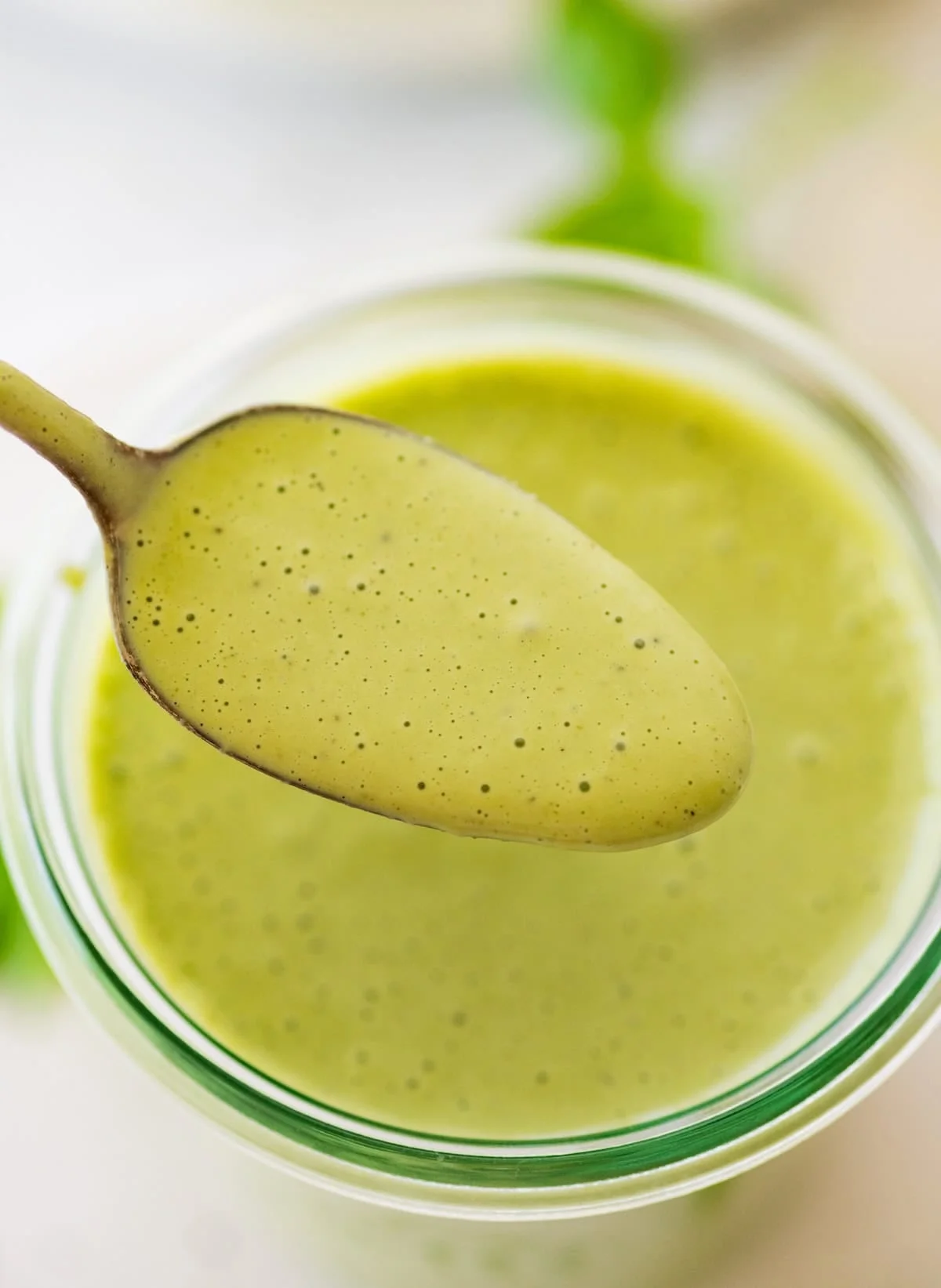 Close-up of a spoonful of thick creamy green dressing