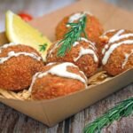 Golden crispy crab cakes with tartar sauce and lemon
