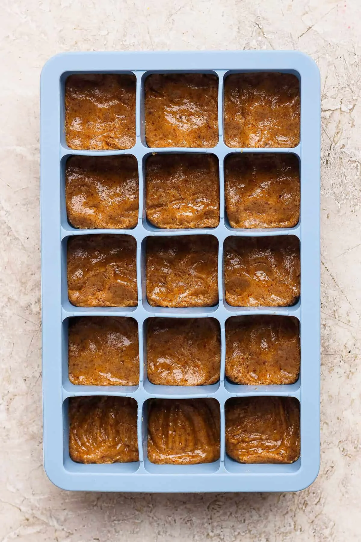 Nut butter base pressed firmly into silicone tray cubes