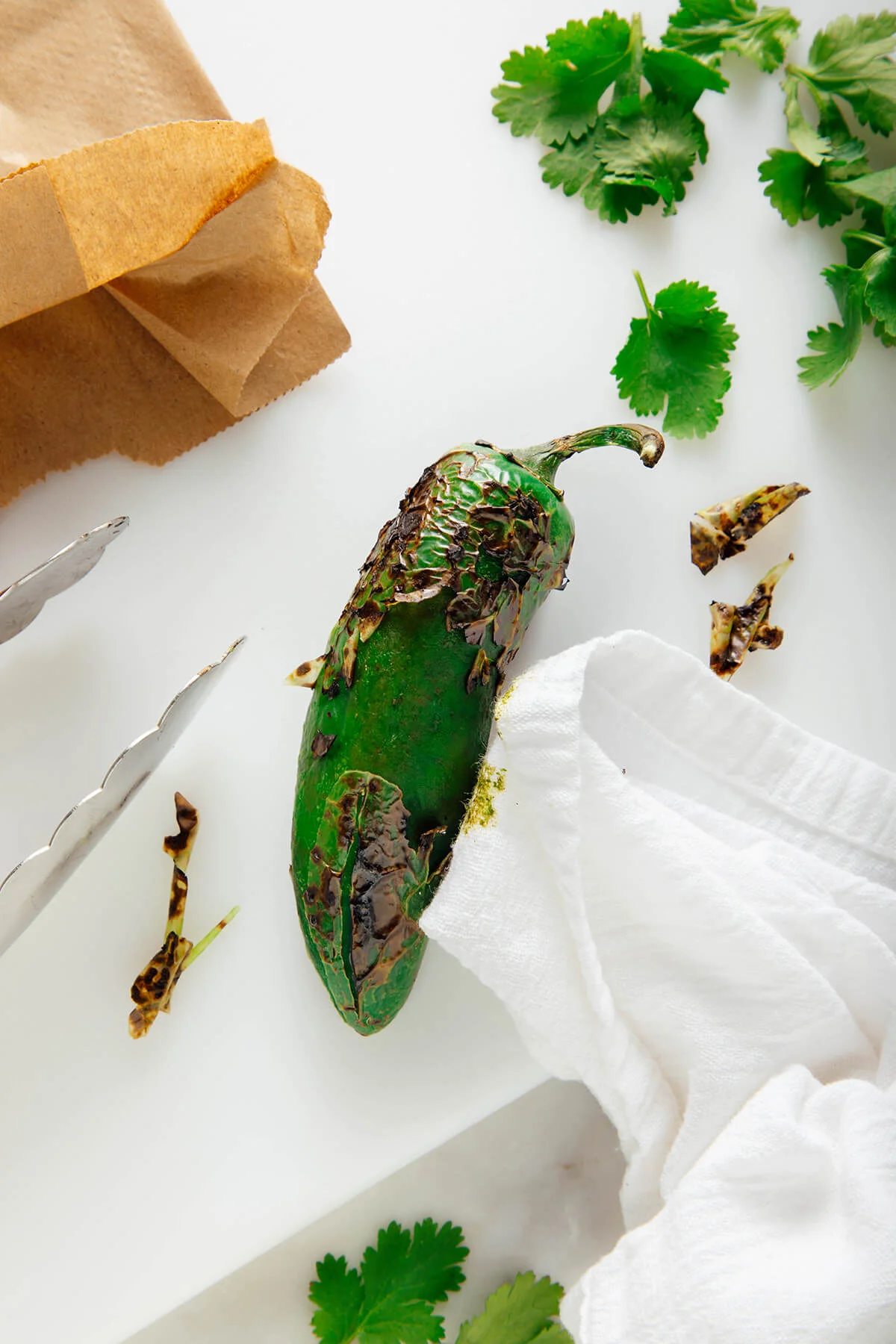 Jalapeño charred black over a gas stove flame